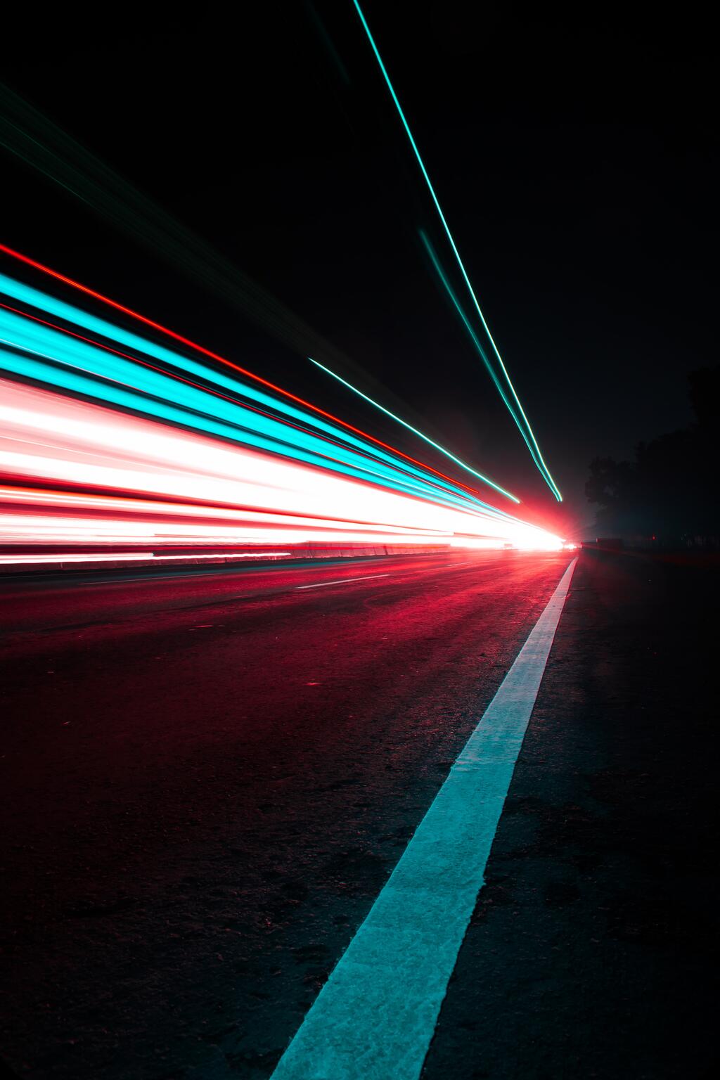 cars running past the camera. The lights are drawnout by the shutter mode of the camera making the lights look like fixed lines of light to the horizon.